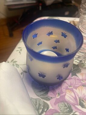 #106 frosted glass candle holder features a blue butterfly motif and a distinct